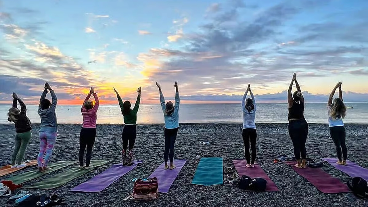 Yoga retreat participant meditating by the Sicilian sea
